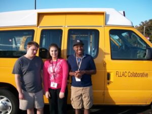 students standing next to van