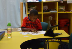 student working independently with communication device at hand