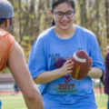 Student handling football.