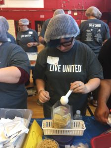 Students preparing meal packs for the needy.