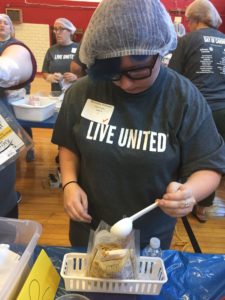 Students preparing meal packs for the needy.