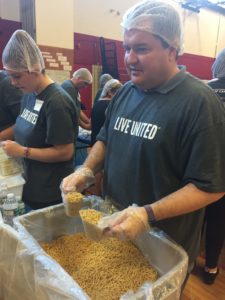 Students and staff preparing meal packs for the needy.