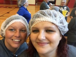 Students and staff preparing meal packs for the needy.