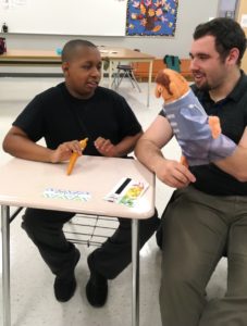 Student and staff singing with the Beatles Puppets.