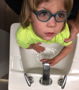 Student washing their hands.