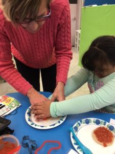 Students making holiday english muffins.