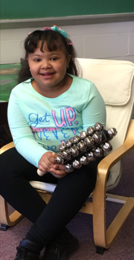 Student making music with bells.
