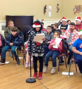 Students caroling at the Senior Center