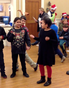 Students caroling at the Senior Center