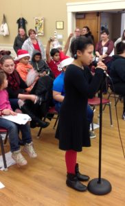 Students caroling at the Senior Center