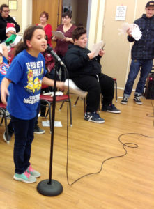 Students caroling at the Senior Center