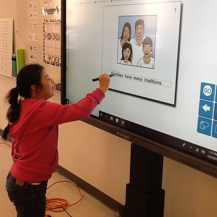 Student working on interactive whiteboard.